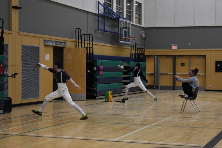 epee fencers lunge to hit the target