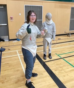 A sabre fencer gives the thumbs up